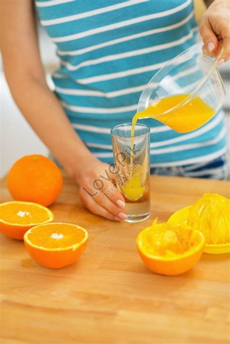 Close Up Of A Woman Pouring Juice Into Glass Picture And Hd Photos