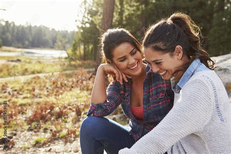 Happy Lesbian Couple Laughing Together In The Countryside Stock Photo