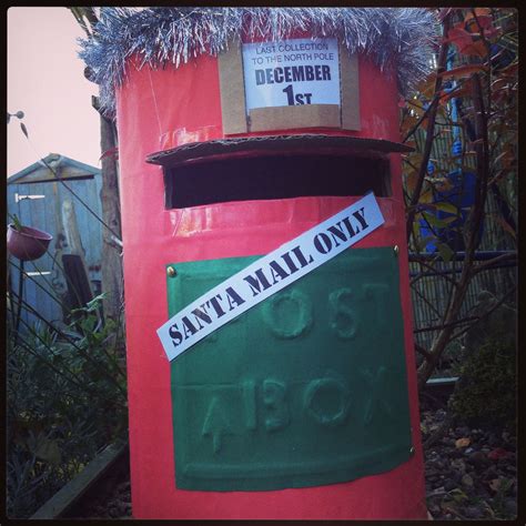 A Red Mailbox With A Sign That Says Santa Mail Only On Its Side