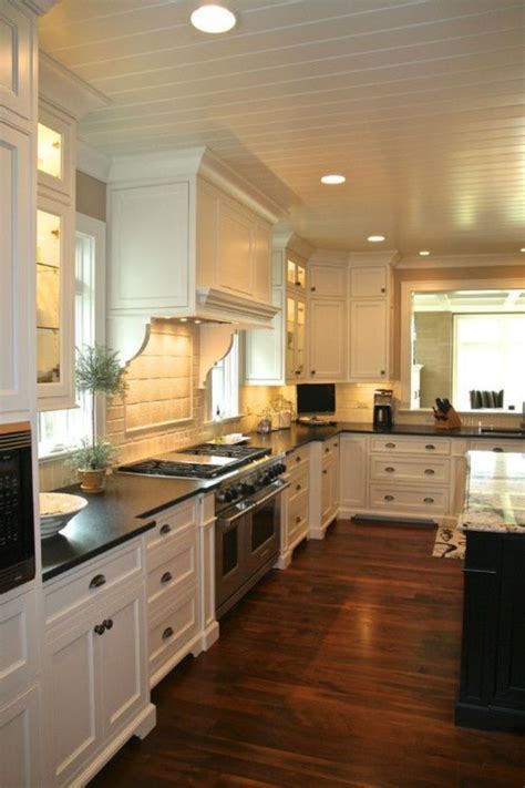 This classy kitchen with black countertops with gooseneck faucet and black backsplash along with glass windows. Elegant Kitchen Light Cabinets with Dark Countertops 40 ...