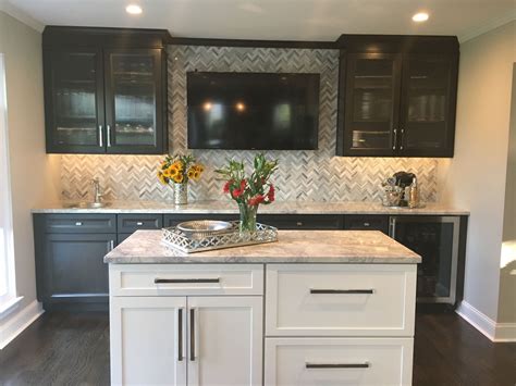 Grey kitchen ,painted gray kitchen cabinets ,paint color ideas for kitchen cabinets ,white and gray kitchen ,dark green kitchen cabinets. Wet bar with dark cabinets, gray and white herringbone ...