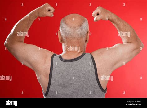 Senior Man Flexing Muscles Rear View Stock Photo Alamy