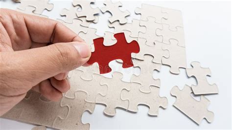 Hand Put Missing Jigsaw Puzzle Into The Paper Board Stock Photo Image