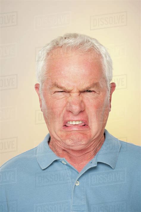 Portrait Of Senior Man With Disgusted Face Expression Stock Photo
