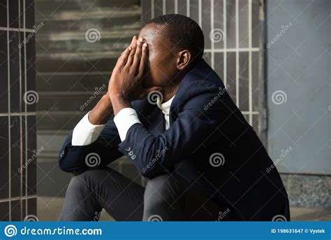 Portrait Of A Sad Depressed Young Man Sitting Outside Stock Image