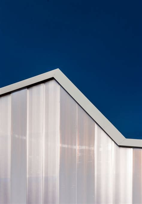 Translucent Polycarbonate Panels Encase The Concrete And Timber