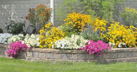 25 retaining wall ideas for stone terrace with cercis and circular stepping stones. 27 Backyard Retaining Wall Ideas and Terraced Gardens