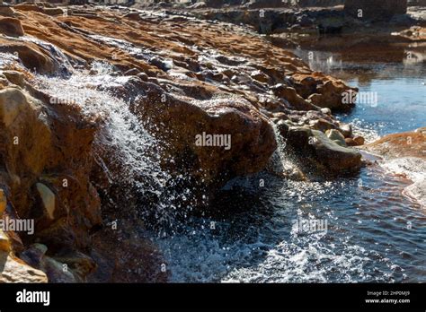 Small Waterfalls Formed By Water Running Over Rocks In The Rio Tinto
