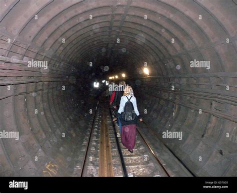 Passengers Walk Along Tube Tracks Towards Stratford East London After They Were Stranded On A