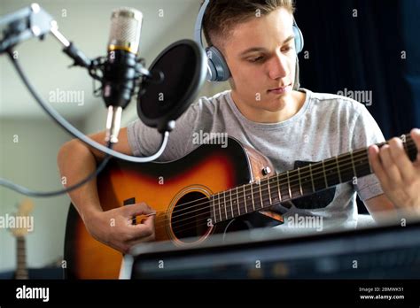 Teenage Boy Playing Guitar And Recording Music At Home Stock Photo Alamy