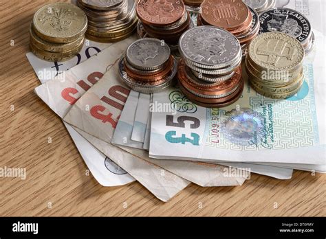 Pile Of Uk Sterling Cash Notes And Coins Stock Photo Alamy