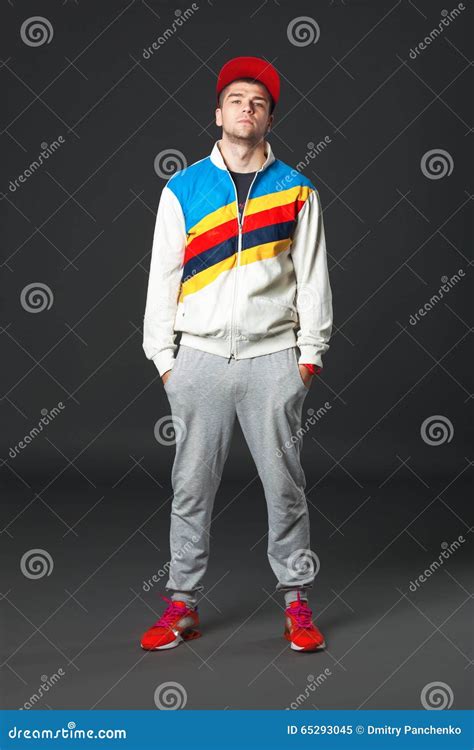 Fullbody Portrait Of Young Cool Man Standing On Dark Background Stock
