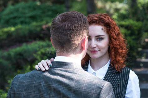 redhead couple portrait of redhead with curly hair wife and defocused husband stock image