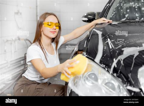 Beautiful Young Woman Wash Car Foam With Yellow Sponge Headlights Stock