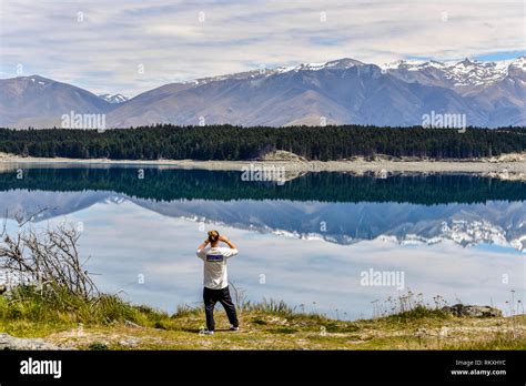 Tourist Taking A Photo At Lake Pukaki New Zealand Stock Photo Alamy