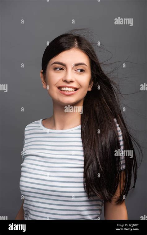 Wind Blowing Through Hair Of Brunette Woman Isolated On Black Stock