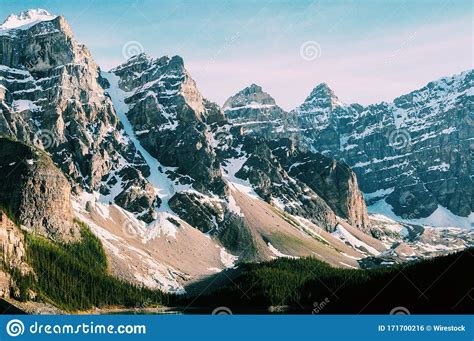 Snow Covered Mountain Peaks Near The Moraine Lake In Canada Stock Photo
