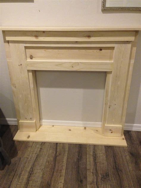 Create a diy faux fireplace mantel with a few pieces of wood, wallpaper and paint! DIY Faux Fireplace & Mantel - Petite Party Studio