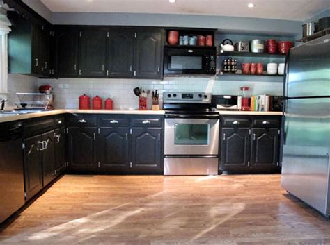 Modern black kitchen cabinets with luxurios pendant lights. Black Kitchen Cabinets with Some White Accents - Traba Homes