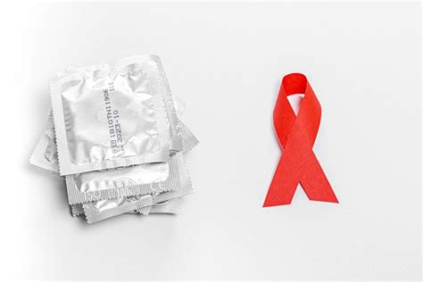 Condoms And Red Ribbon On A White Background The Concept Of Protection