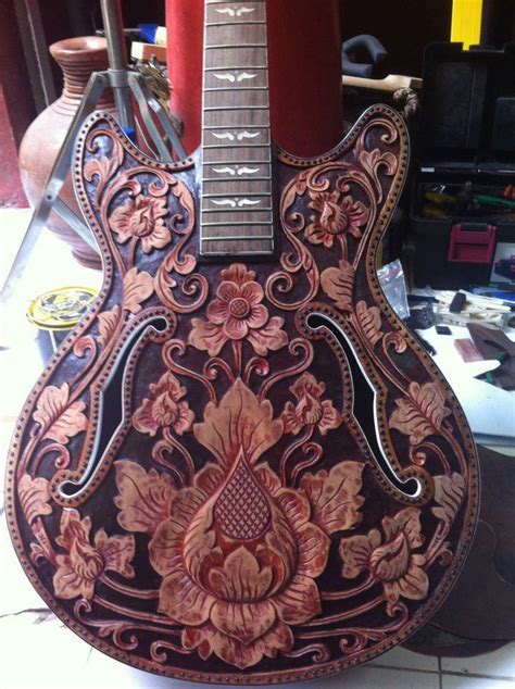 An Intricately Decorated Guitar Sitting On Top Of A Table