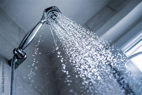 Water Running From Shower Head And Faucet In The Bathroom Stock Photo