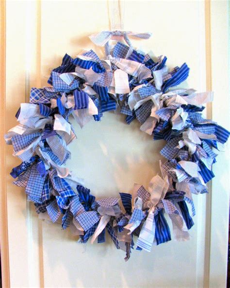 A Blue And White Wreath Hanging On The Front Door With Paper Streamers