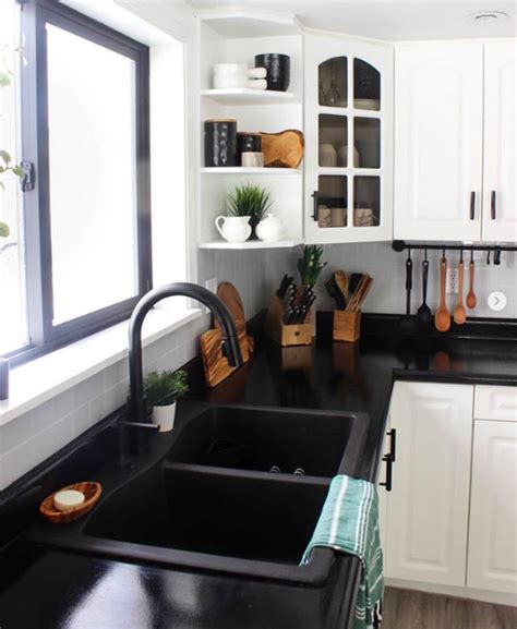 Green patterned bar stools sit at a minimalist kitchen showcases tall white cabinetry with black double wall oven inset. 10 Pics That Prove Black Sinks Are the Coolest New Kitchen ...
