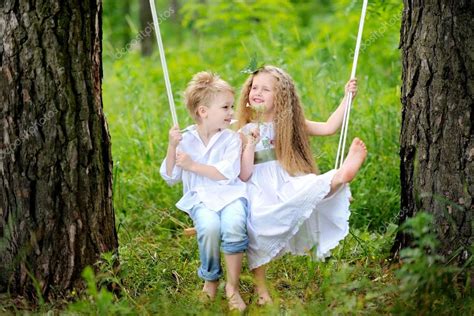 Portrait Of Little Boys And Girls Outdoors In Summer Stock Photo By