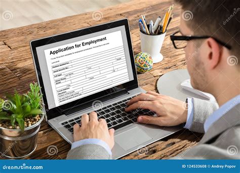 Businessman Filling Application For Employment Form On Laptop Stock