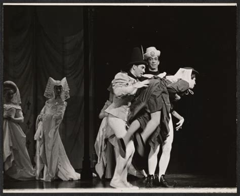 An Old Black And White Photo Of People In Costume On Stage With One Man Holding The Other