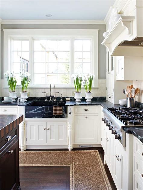 Here, gold handles connect white cabinets to complementary light green cabinetry beneath a white marble counter. Pairing Dark Countertops With Light Cabinets For A ...