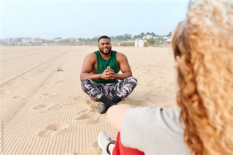 Fit Man Talking To A Friend At The Beach By Stocksy Contributor Ivan Gener Stocksy