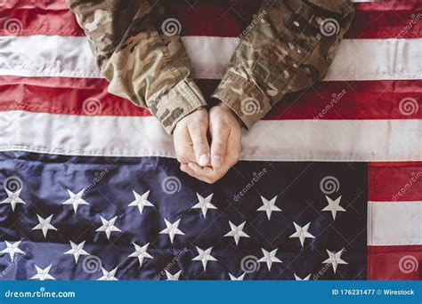 American Soldier Mourning And Praying With The American Flag In Front