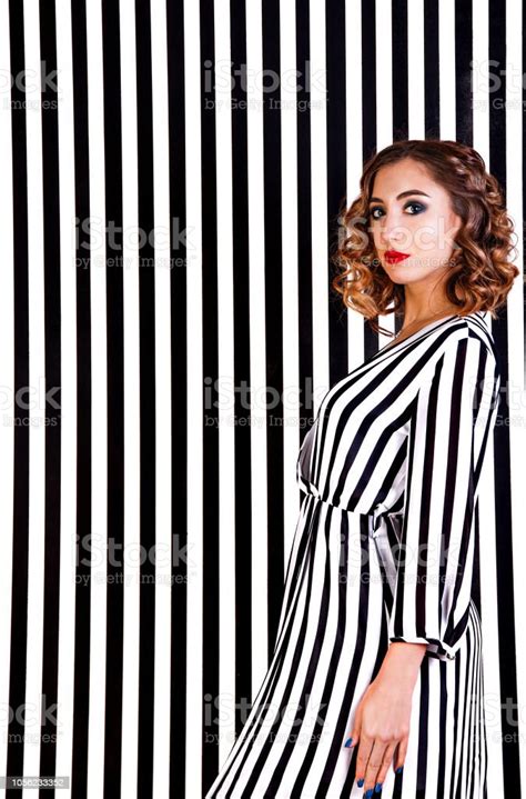 Girl At The Background Of Black And White Stripes Stock Photo