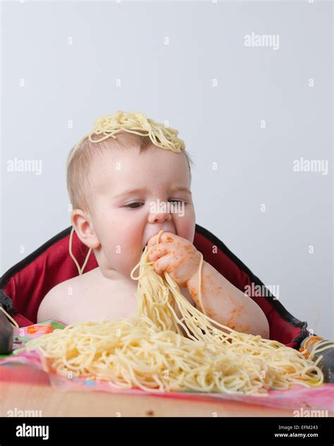 12 Month Old Baby Eating Pasta Stock Photo Alamy