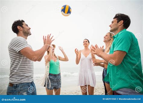 Group Of Friends Playing With A Beach Ball Stock Photo Image Of