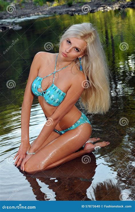 Glamour Blond Model With Body In Blue Bikini Posing Pretty At The Nature Location Stock Photo