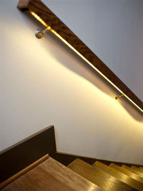 This stair railing successfully intersects a laidback, beachystyle (greyed out wood looks like driftwood) with cottage, barn, or farmhouse appeal in the x spiral staircase with glass railings and lights. Modern Lighting Ideas That Turn The Staircase Into A ...