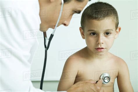 Doctor Listening To Boys Chest With Stethoscope Stock Photo Dissolve