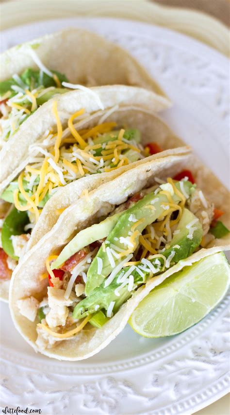 The smoke and spice of fresh hatch green chiles with sweet honey over crispy oven roasted chicken thighs. {Crockpot} Salsa Verde Honey Lime Chicken Tacos - A Latte Food