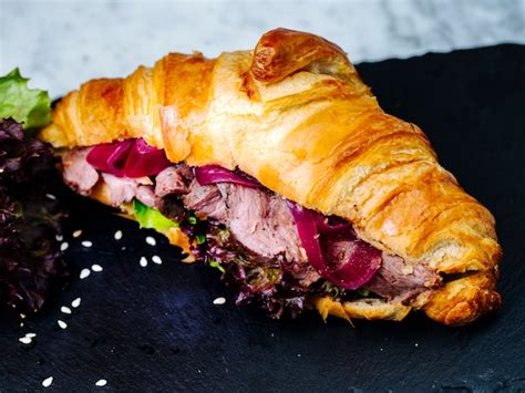 free photo croissants filled with sliced meat and herbs