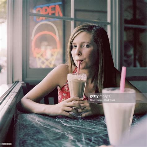A Teenage Girl Drinking A Milkshake In A Diner Photo Getty Images