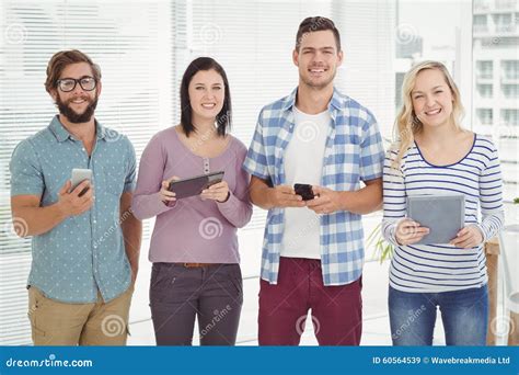 Portrait Of Smiling Business People Using Electronic Gadgets Stock