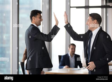 Happy Excited Executive Colleagues Businessmen Giving High Five In