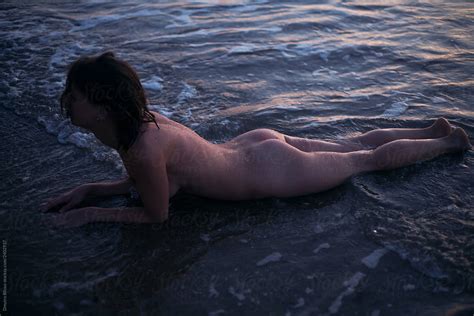 Naked Girl Lying In The Water By Stocksy Contributor Demetr White