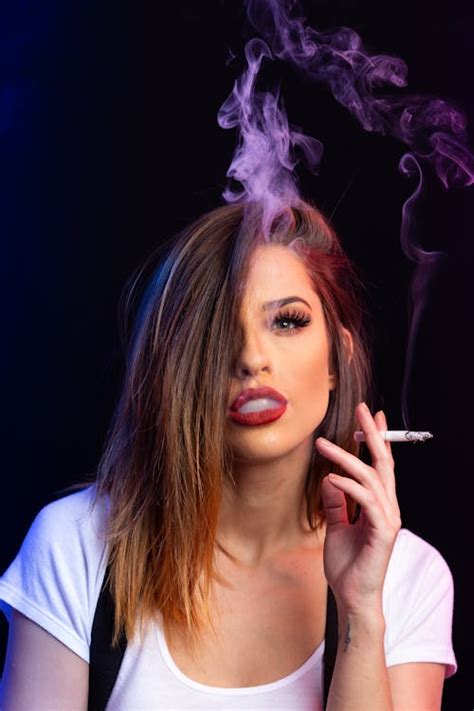 Woman In White Shirt Smoking Cigarette · Free Stock Photo