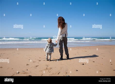 Baby And Mother Holding Hands In Beach Stock Photo Alamy