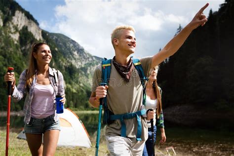 Group Of Happy Friends With Backpacks Hiking Together Stock Image
