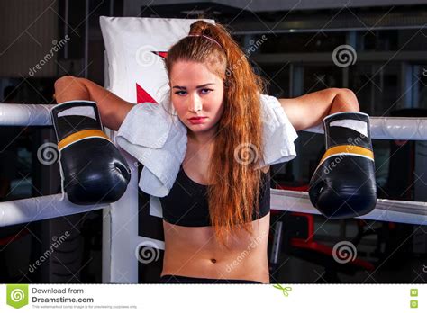 Girl Wearing Sport Gloves Sitting In Corner Of Boxing Ring Stock Image